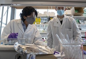 parisa with a student in a lab
