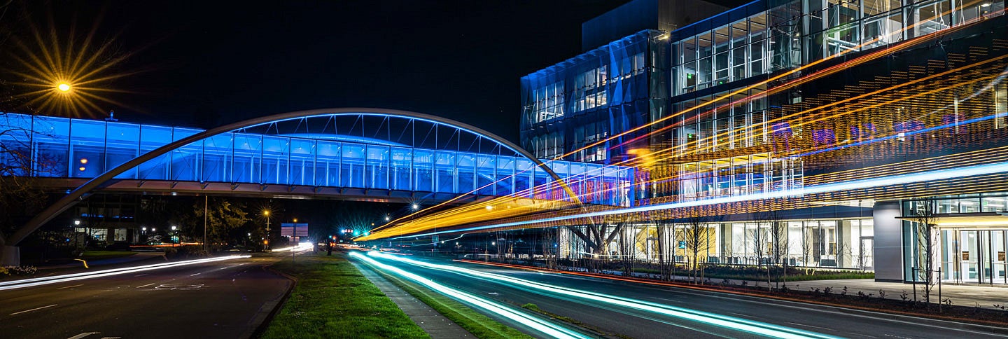 Knight Campus Sky Bridge at night with blurred colored lights open shutter effect cropped