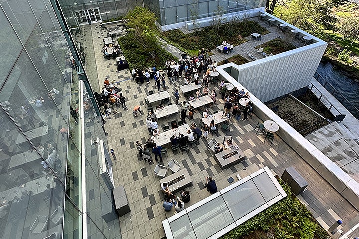 A large group of people at an event on an outdoor terrace