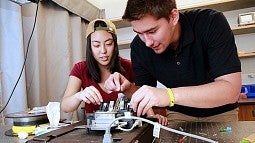 students working at an optics table