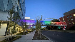 Knight Campus Sky Bridge illuminated in rainbow colors for Pride Month 2022