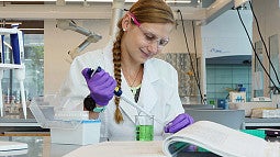 A person in a lab using scientific equipment
