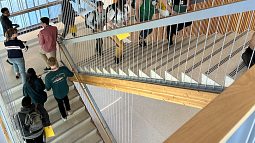 Students from the 2023 cohort of the Knight Campus Graduate Internship Program climb the stairs on their first day of classes on June 21, 2023