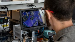 Image of researcher looking at screen in lab