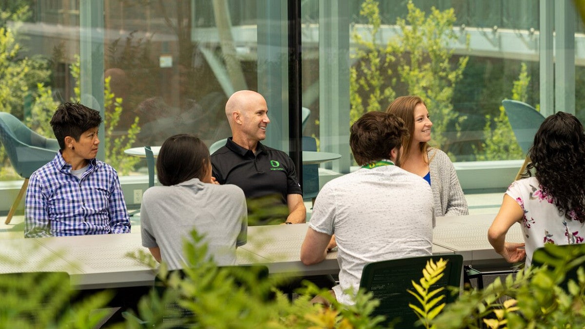 Knight Campus Executive Director Bob Guldberg and students on the Knight Campus Terrace