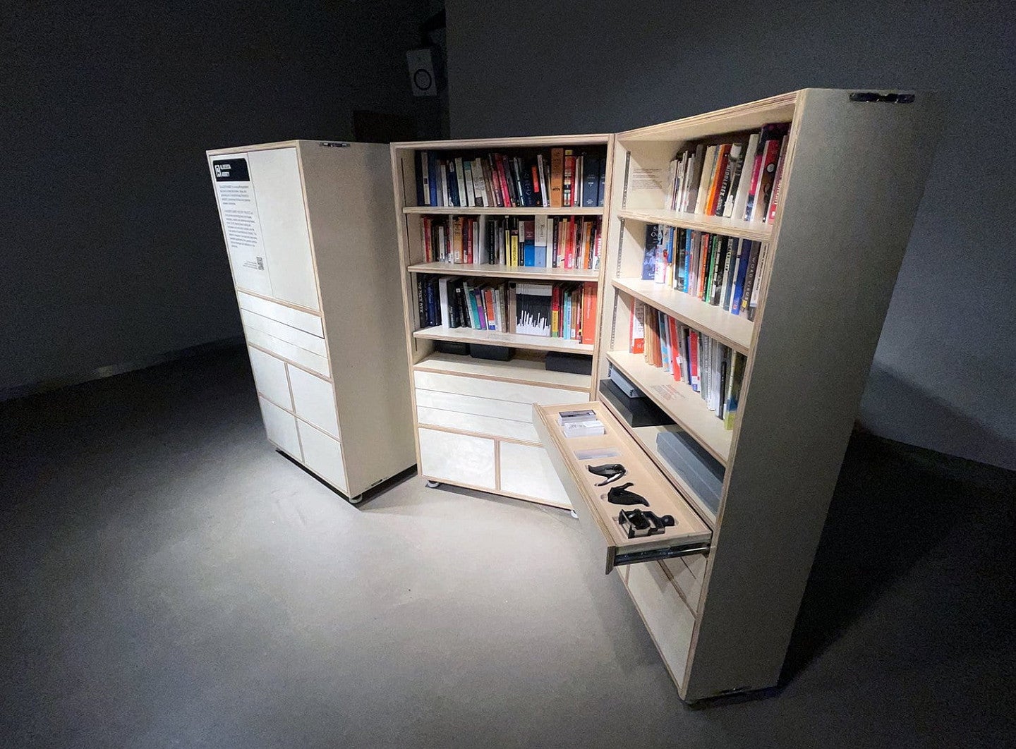 A tall bookcase with doors and drawers